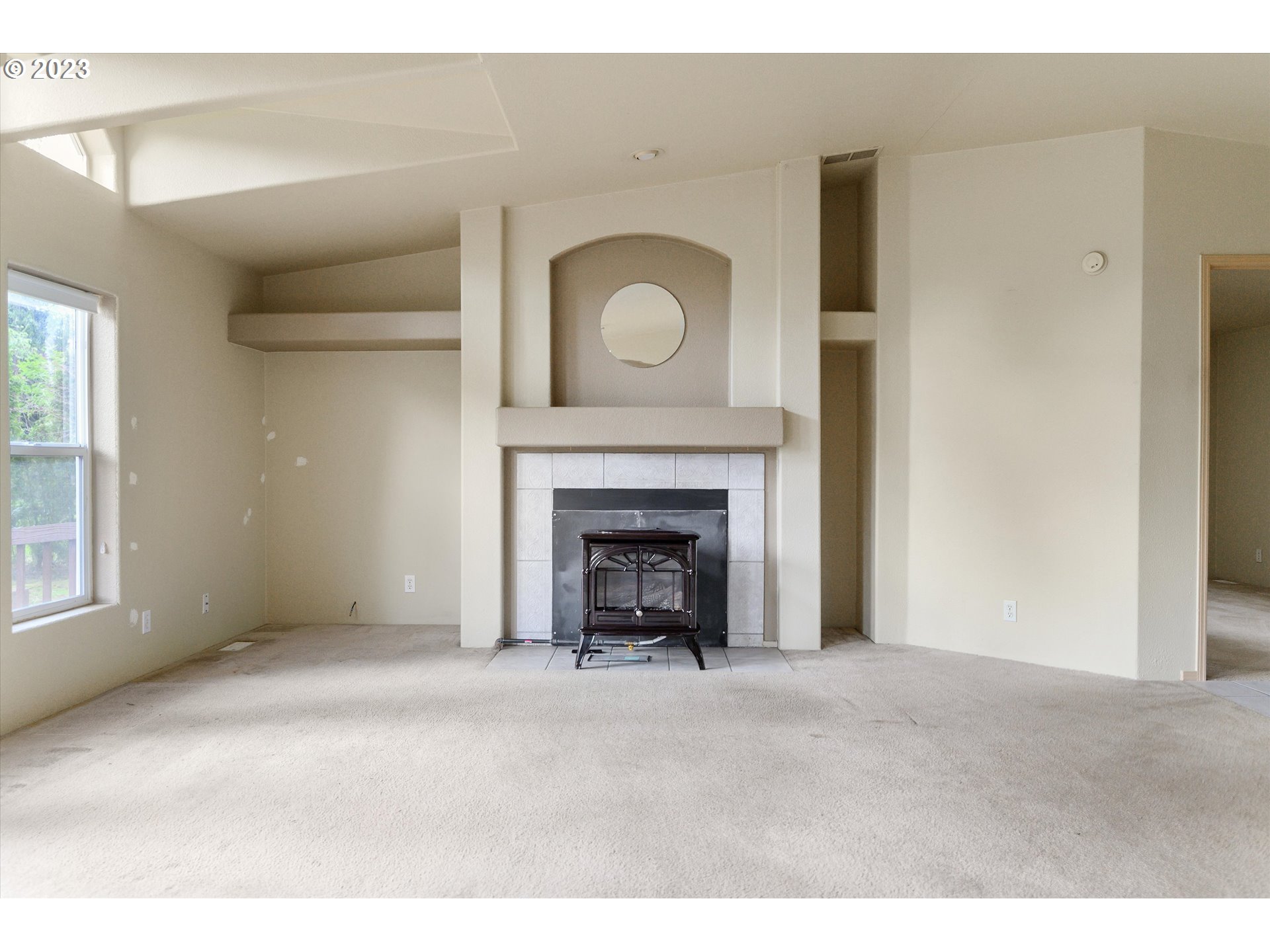 42264 Southeast Locksmith Lane Sandy, OR 97055 - Photo 5 of 36 a view of an empty room with a fireplace and a window