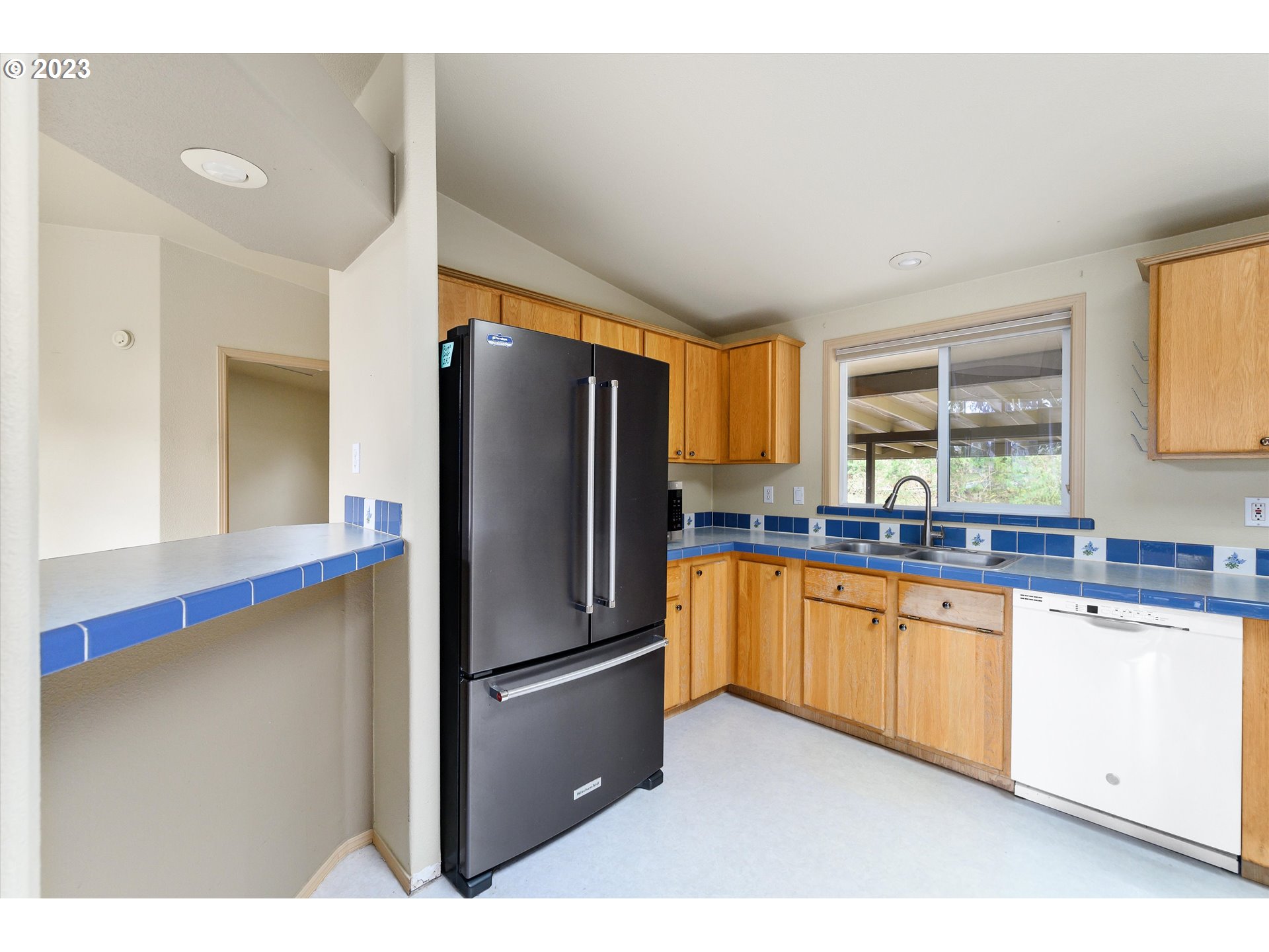 42264 Southeast Locksmith Lane Sandy, OR 97055 - Photo 8 of 36 a kitchen with stainless steel appliances granite countertop a refrigerator and a sink