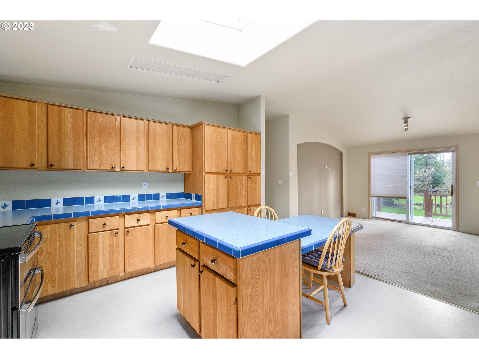 42264 Southeast Locksmith Lane Sandy, OR 97055 - Photo 9 of 36 a kitchen with stainless steel appliances granite countertop a table chairs sink and cabinets