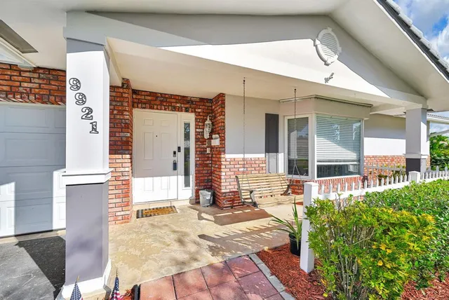 a view of a house with swimming pool and sitting area