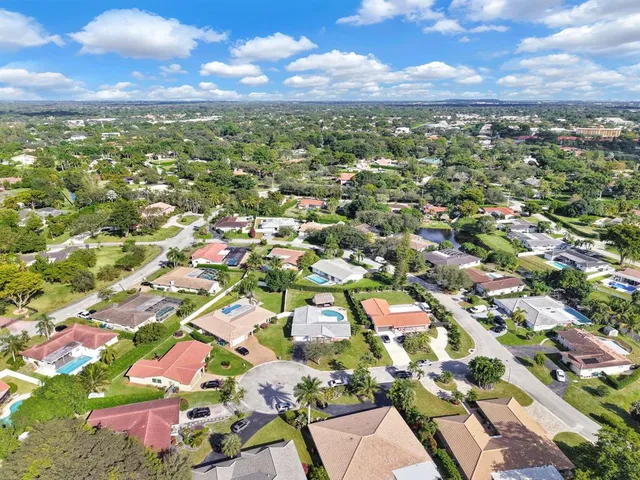 an aerial view of residential houses with city view