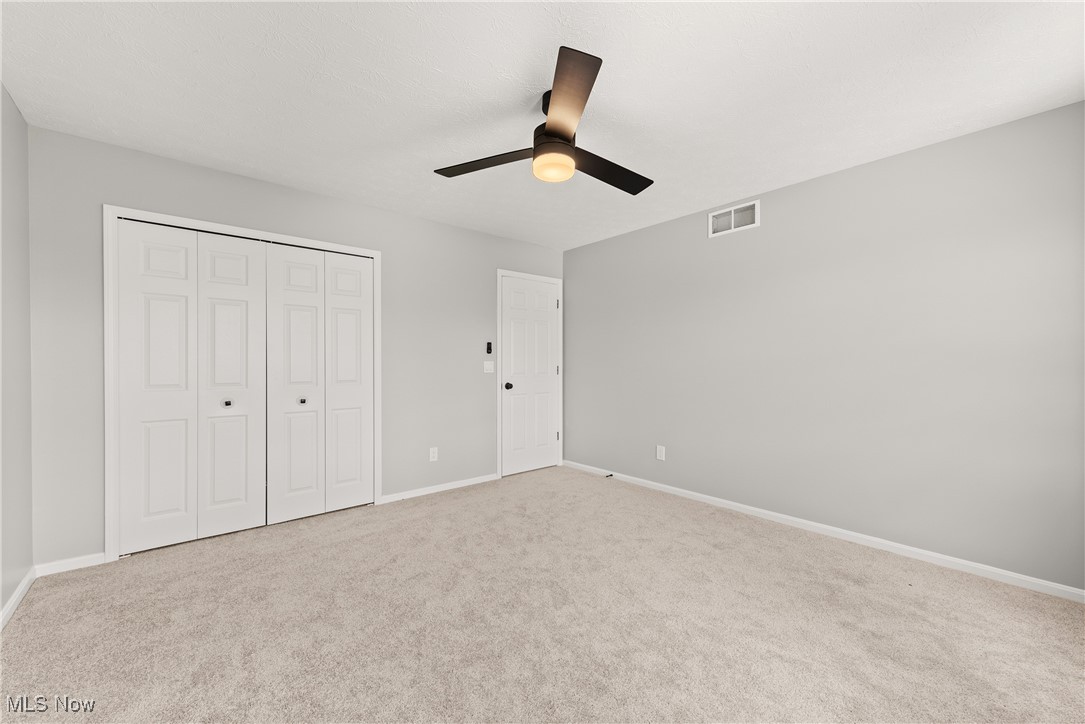 8080 Fair Road Strongsville, OH 44149 - Photo 34 of 50 Unfurnished bedroom with carpet flooring, baseboards, a closet, and ceiling fan