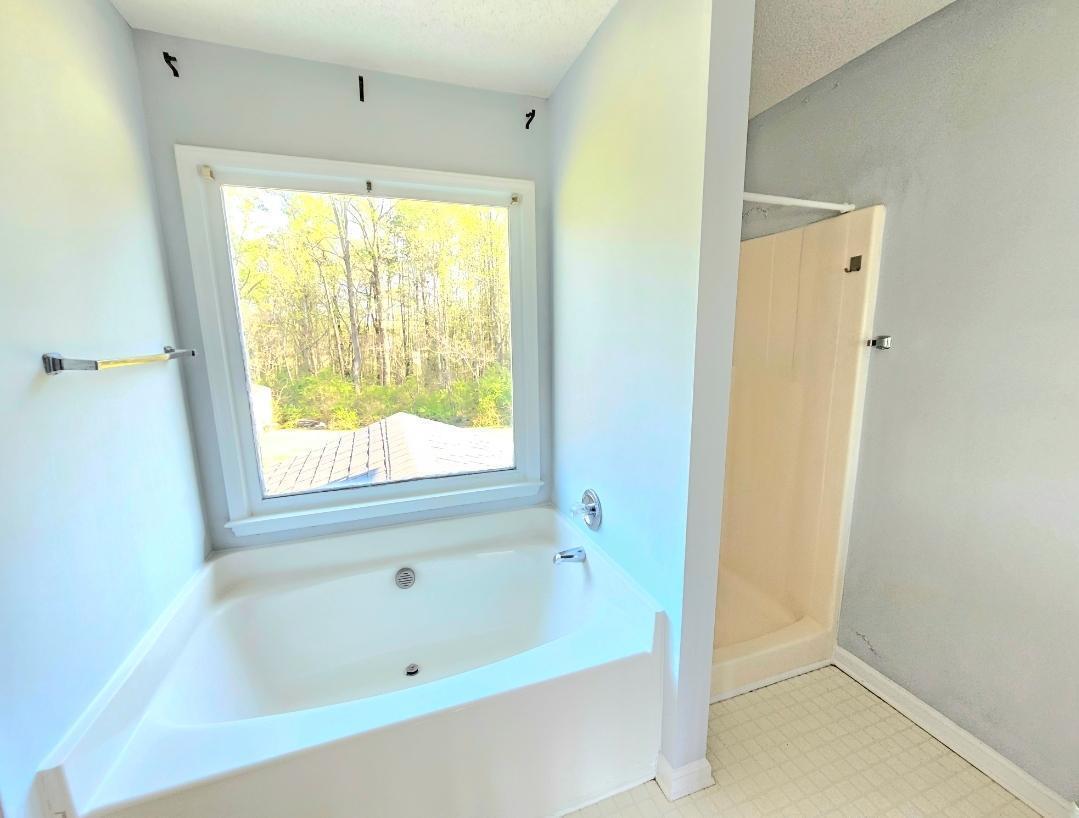a bathroom with a bathtub and shower