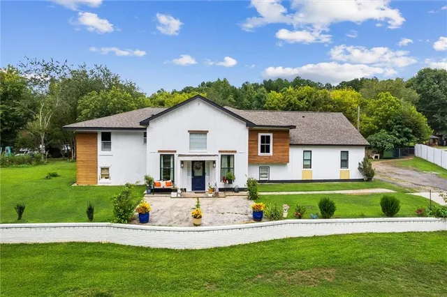 a front view of house with yard and outdoor seating