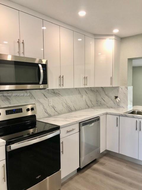 3440 Southwest 7th Street, Unit 1 Miami, FL 33135 - Photo 13 of 14 a kitchen with stainless steel appliances a stove a microwave and sink