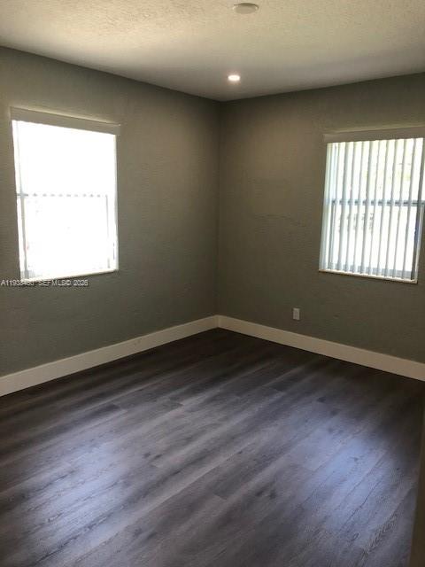 3440 Southwest 7th Street, Unit 1 Miami, FL 33135 - Photo 8 of 14 an empty room with wooden floor and windows