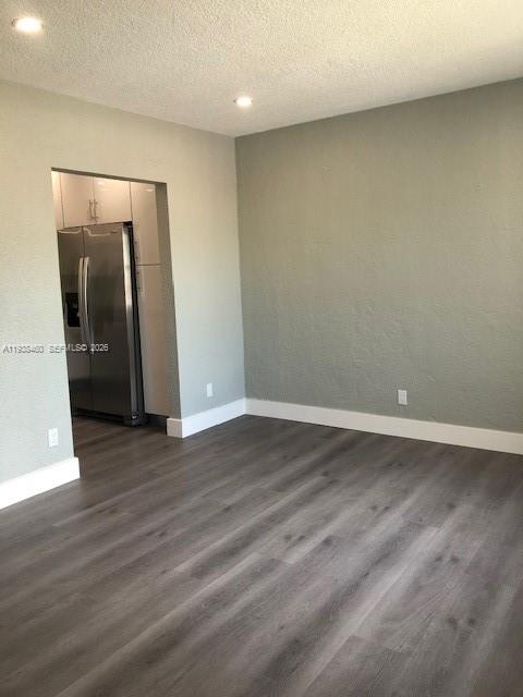 3440 Southwest 7th Street, Unit 1 Miami, FL 33135 - Photo 10 of 14 an empty room with wooden floor and mirror