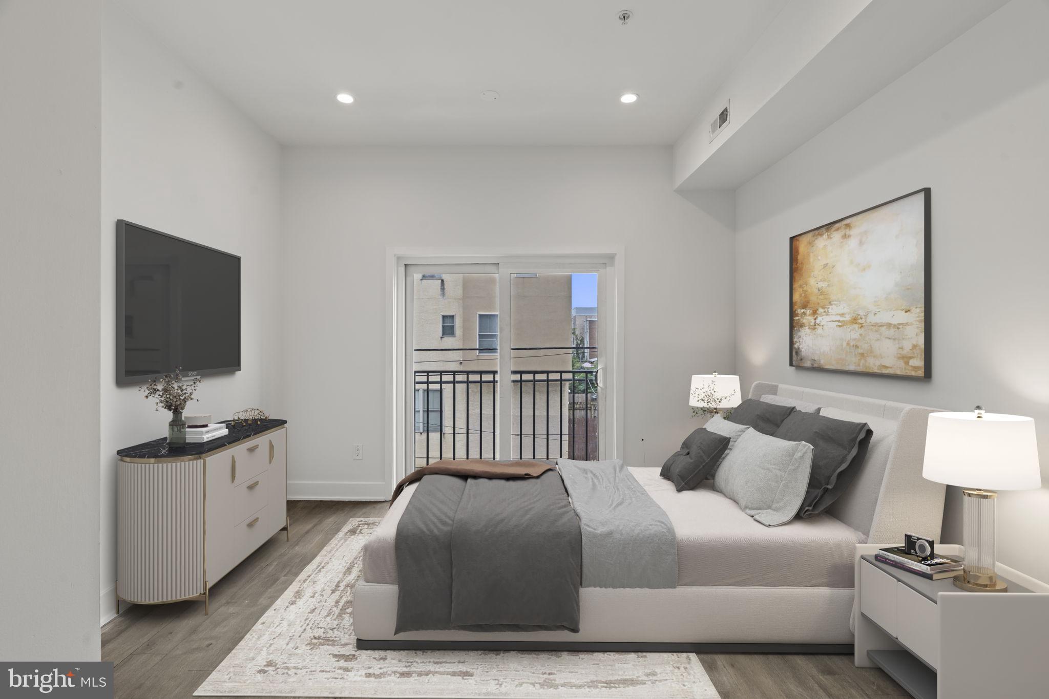 1244 South 20th Street, Unit 2 Philadelphia, PA 19146 - Photo 11 of 28 a bedroom with a bed and a flat screen tv