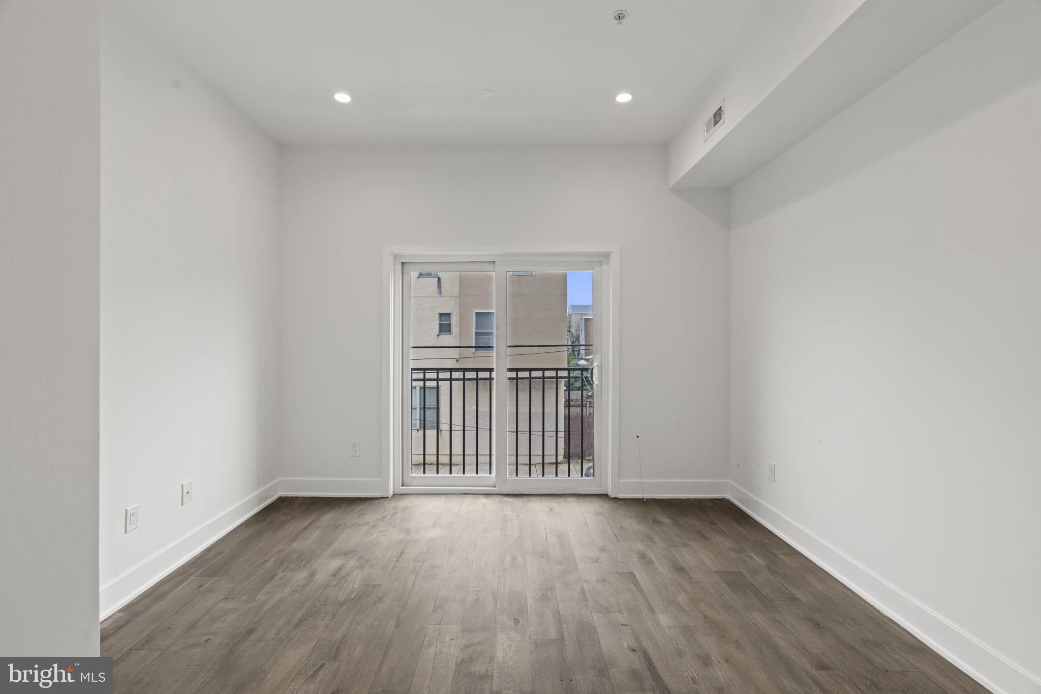 1244 South 20th Street, Unit 2 Philadelphia, PA 19146 - Photo 12 of 28 a view of a room with wooden floor and a window