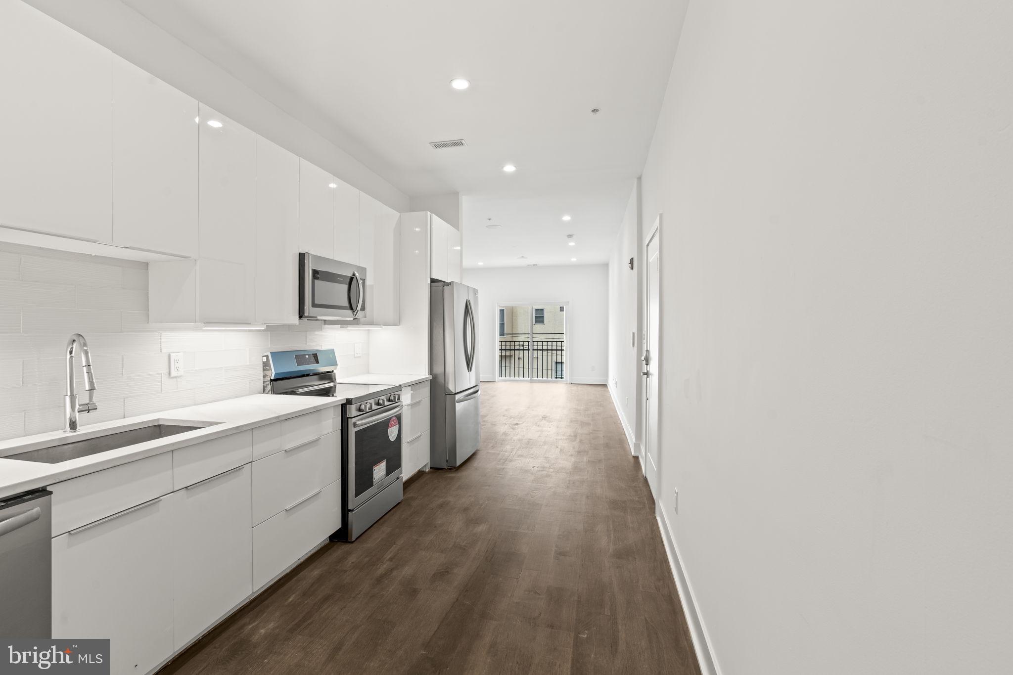 1244 South 20th Street, Unit 2 Philadelphia, PA 19146 - Photo 10 of 28 a large kitchen with a lot of counter space