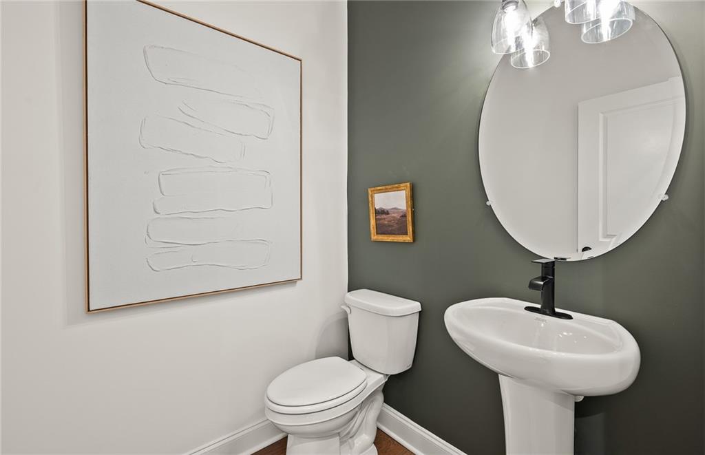 1601 Wander Mill Cumming, GA 30040 - Photo 18 of 32 a bathroom with a toilet sink and mirror