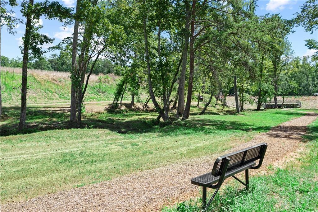 1601 Wander Mill Cumming, GA 30040 - Photo 32 of 32 a wooden bench sitting in the middle of a park