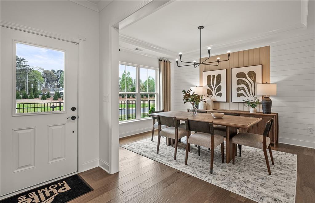 1601 Wander Mill Cumming, GA 30040 - Photo 4 of 32 a view of a dining room with furniture window and wooden floor
