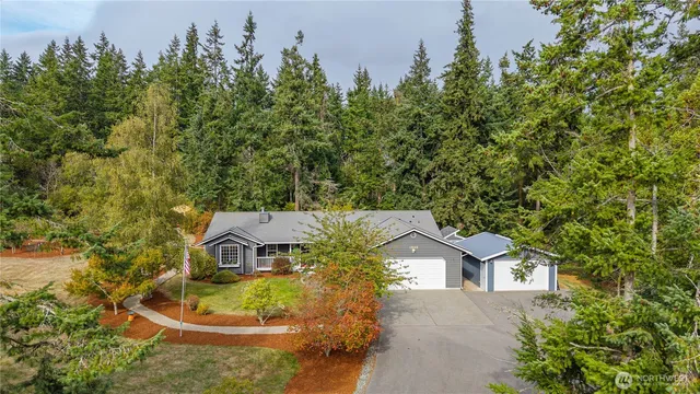 an aerial view of a house with swimming pool and garden