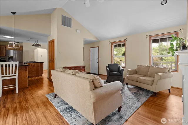 a living room with furniture and a wooden floor