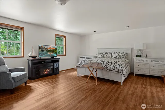 a bedroom with furniture and a wooden floor