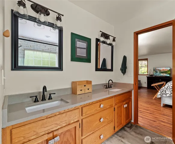 a bathroom with 2 sink and a mirror