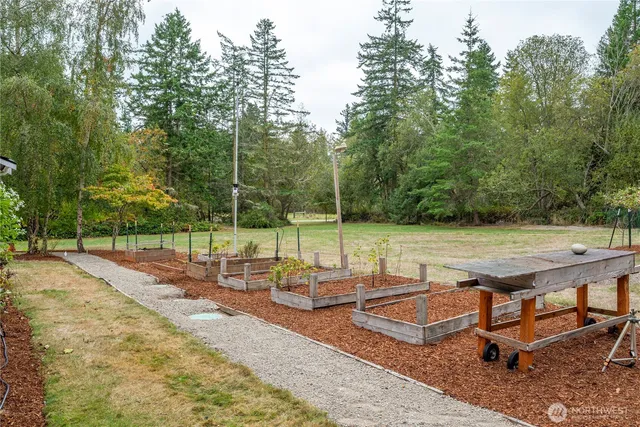 a view of a backyard with wooden floor and fence