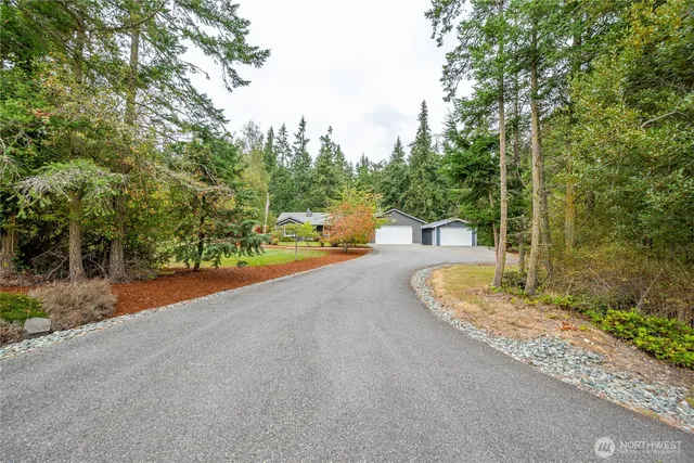 a view of a house with a yard and sitting area
