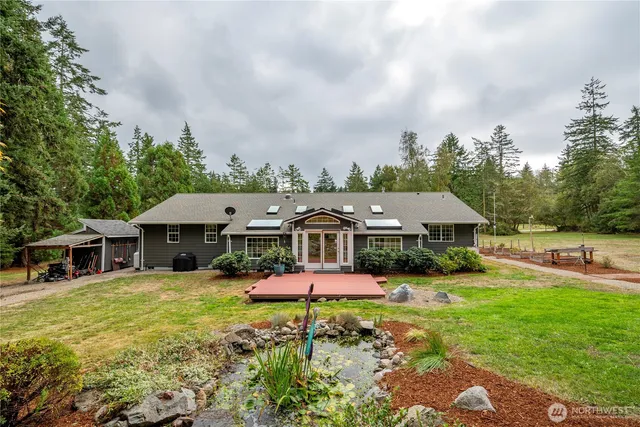 an aerial view of a house with garden space and wooden fence