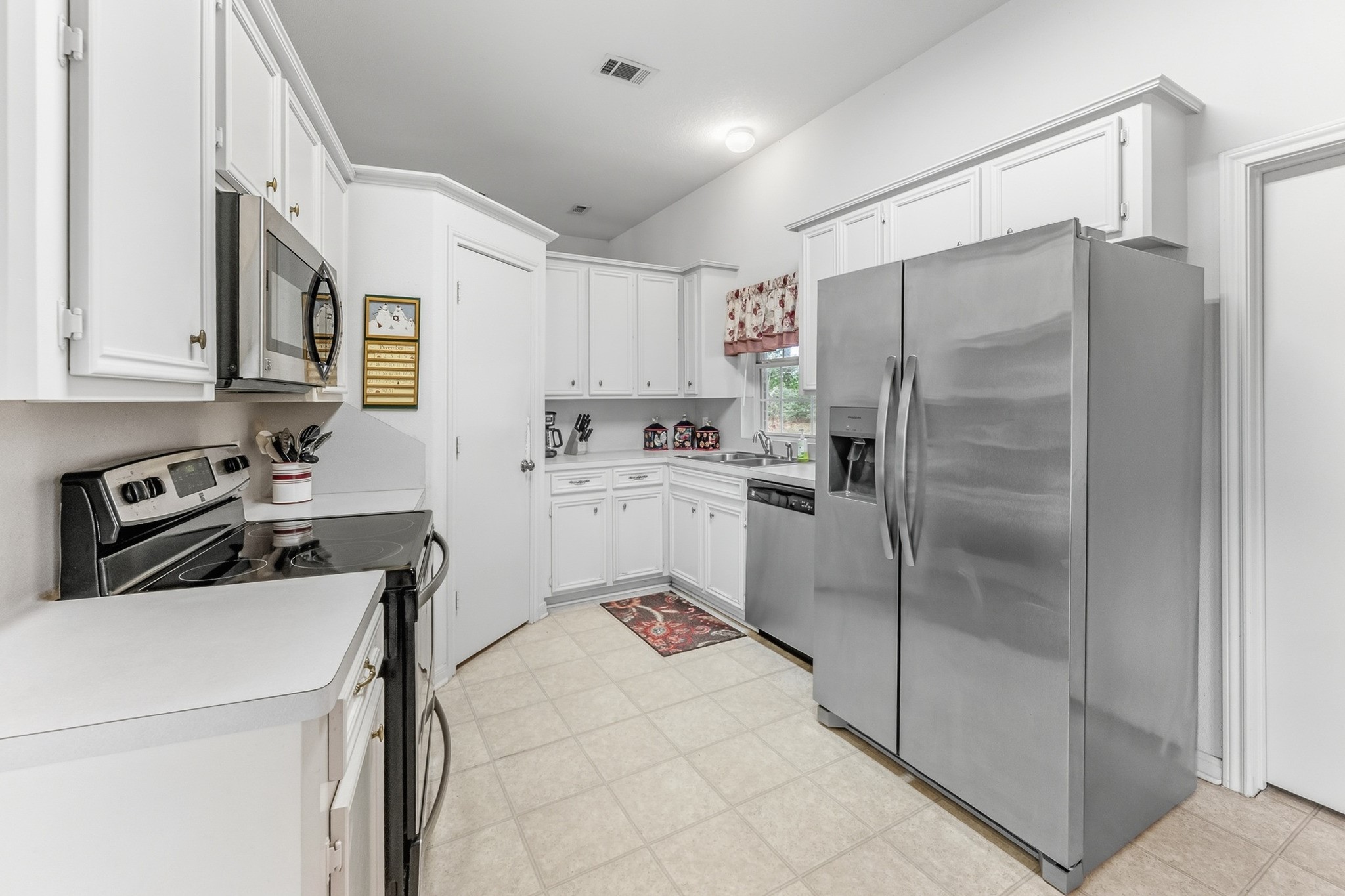 691 Bishop Road Huntsville, TX 77320 - Photo 10 of 32 a kitchen with stainless steel appliances a refrigerator sink and cabinets