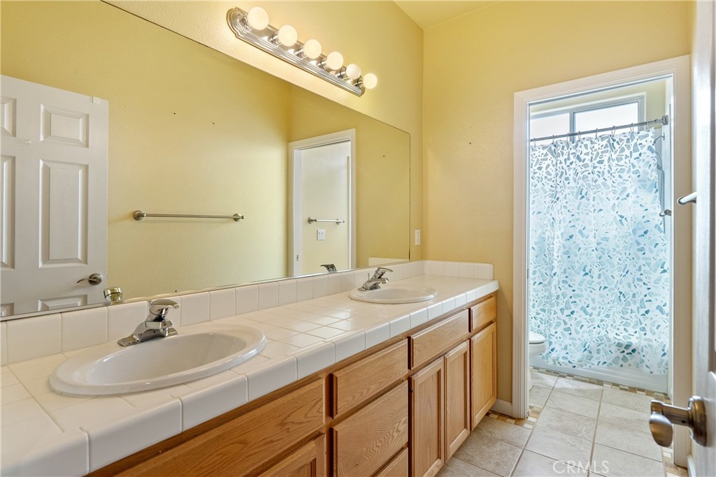 830 Sycamore Canyon Road Paso Robles, CA 93446 - Photo 15 of 27 a bathroom with a sink and a mirror