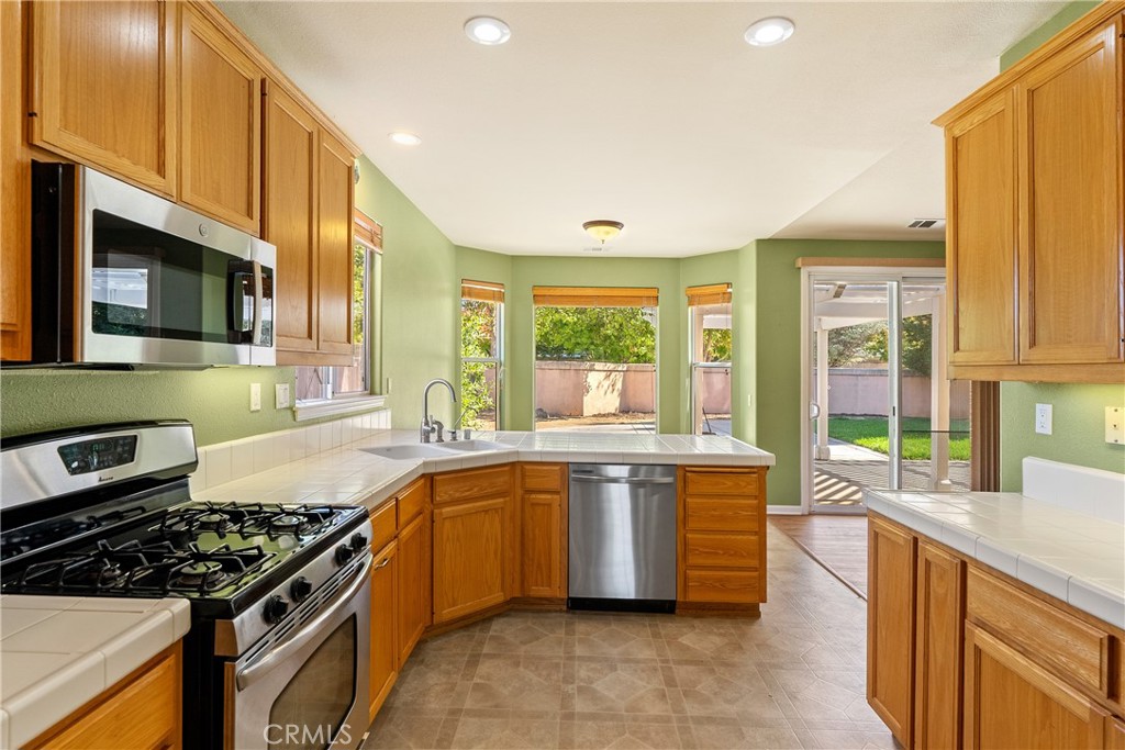 830 Sycamore Canyon Road Paso Robles, CA 93446 - Photo 6 of 27 a kitchen with stainless steel appliances a sink stove and cabinets