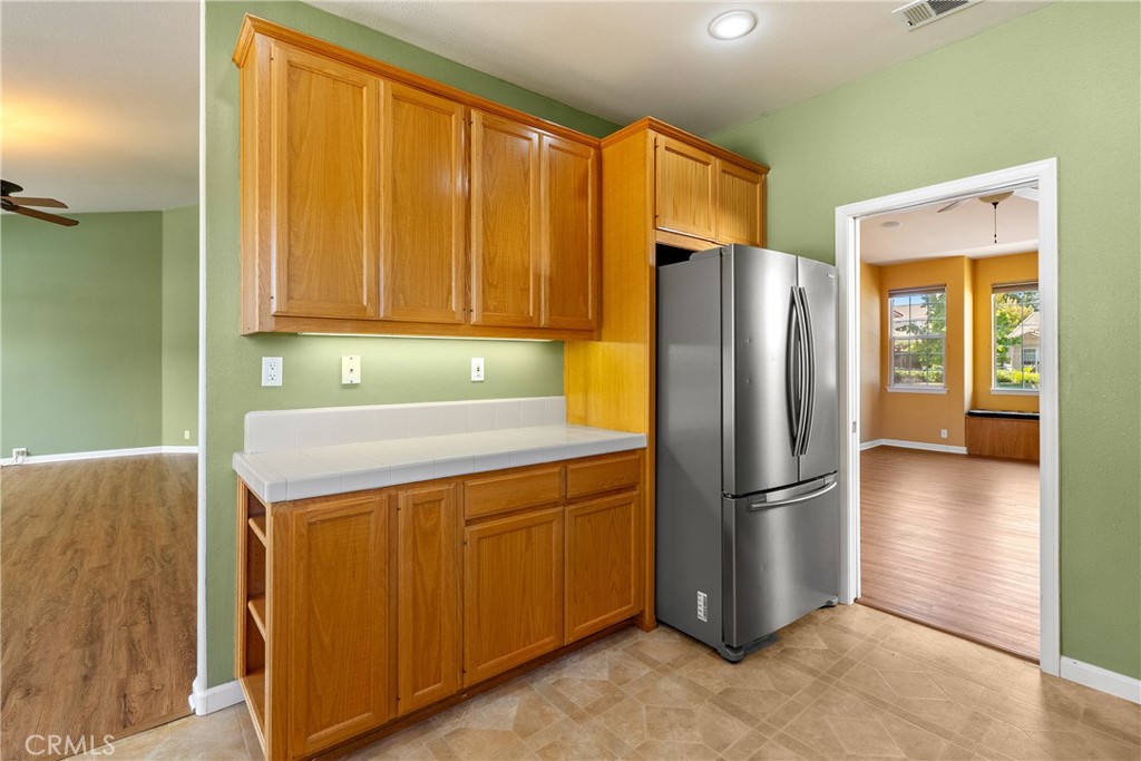 830 Sycamore Canyon Road Paso Robles, CA 93446 - Photo 7 of 27 a kitchen with a refrigerator a stove top oven and cabinets