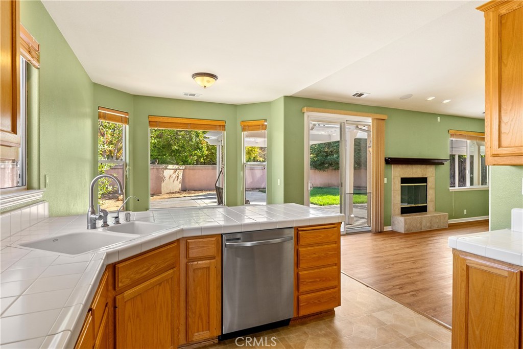 830 Sycamore Canyon Road Paso Robles, CA 93446 - Photo 10 of 27 a kitchen with stainless steel appliances granite countertop a sink and a wooden cabinets