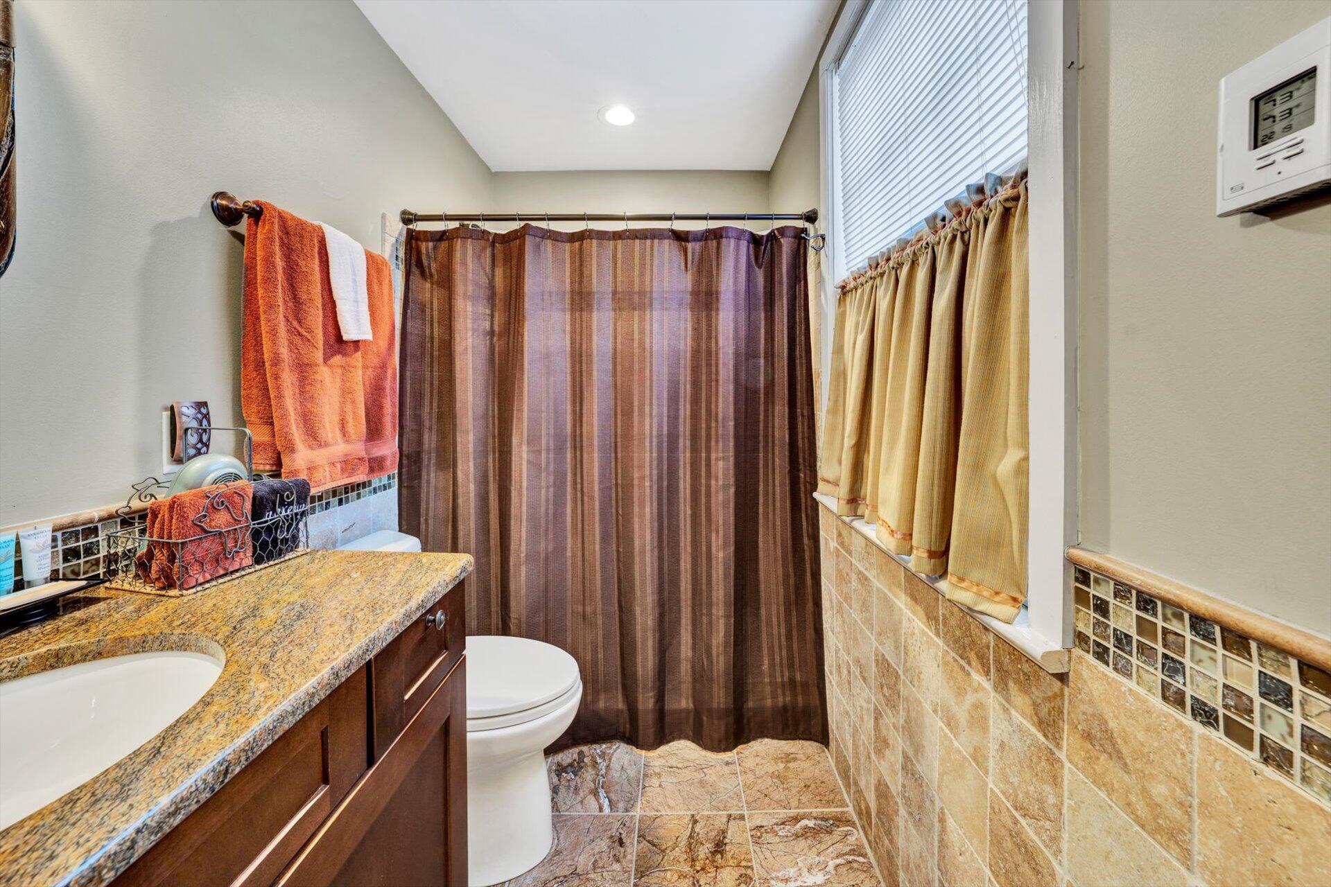 50 Floyd Avenue Rocky Mount, VA 24151 - Photo 19 of 73 a bathroom with a granite countertop sink and a mirror