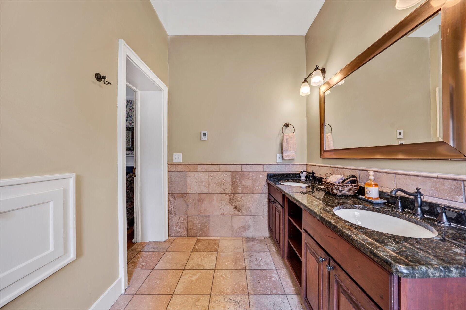 50 Floyd Avenue Rocky Mount, VA 24151 - Photo 35 of 73 a bathroom with a granite countertop sink a mirror and a shower