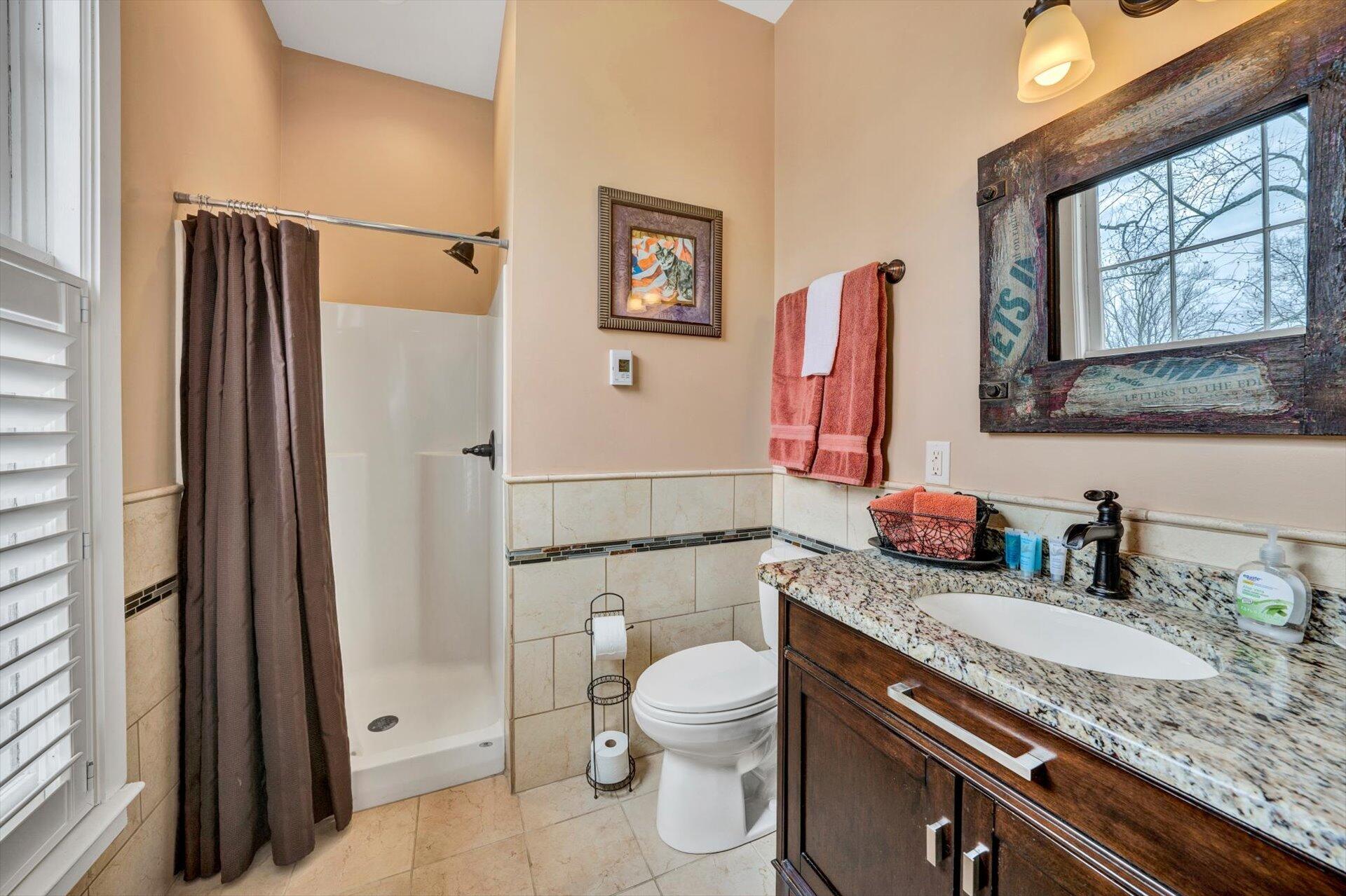 50 Floyd Avenue Rocky Mount, VA 24151 - Photo 44 of 73 a bathroom with a granite countertop toilet sink and shower
