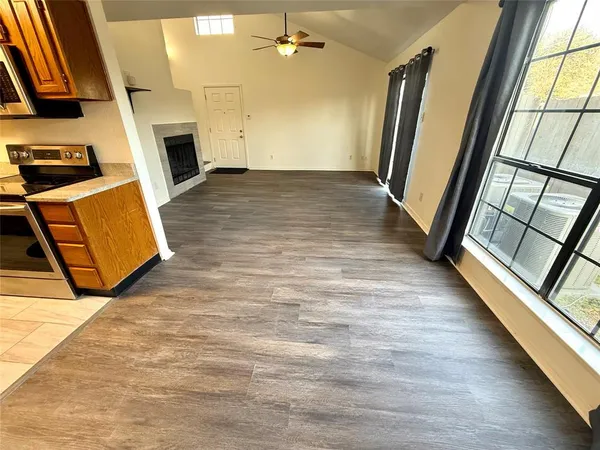 wooden floor in an empty room with a fireplace