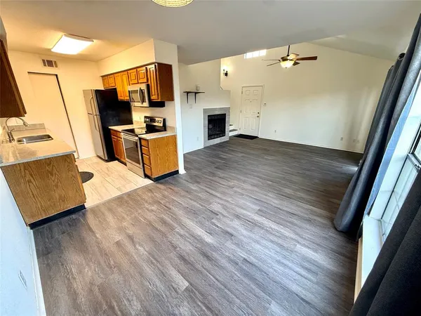 wooden floor in an empty room with a fireplace