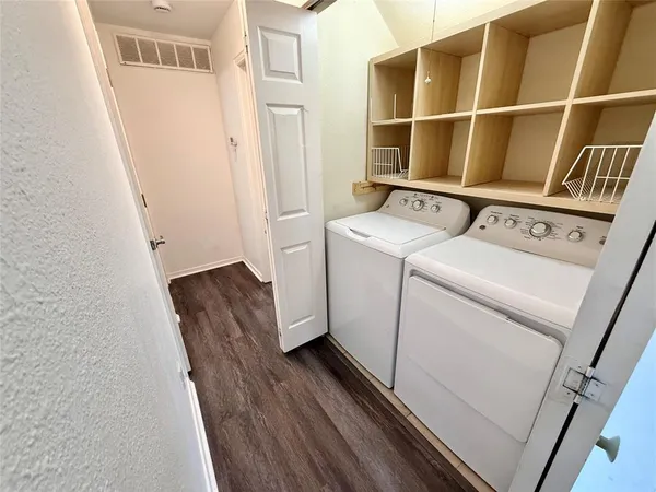 a view of washer and dryer with wooden floor