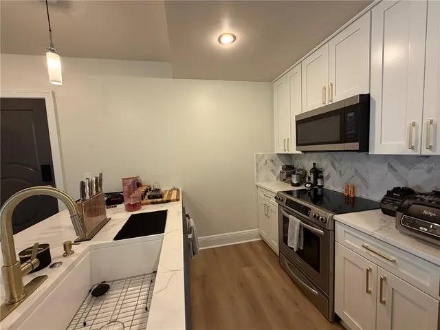 a kitchen with a sink and a stove top oven