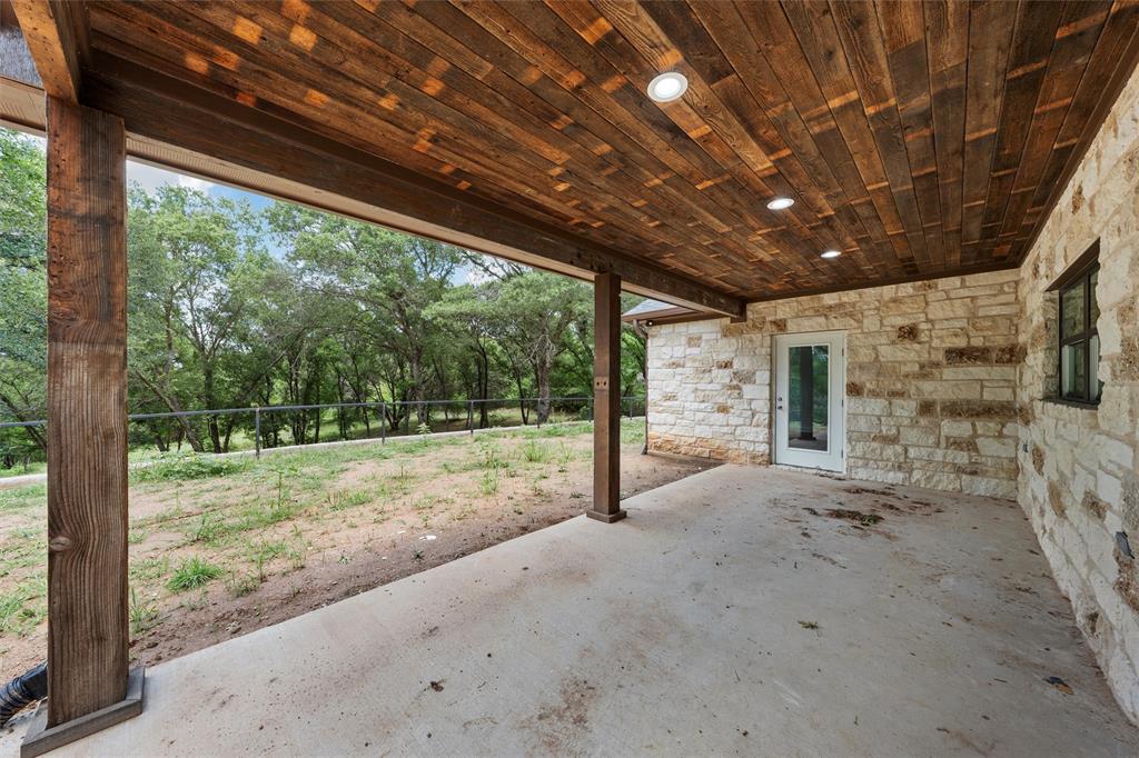 1698 Rogers Hill Road Waco, TX 76705 - Photo 31 of 40 View of patio with view of wooded area