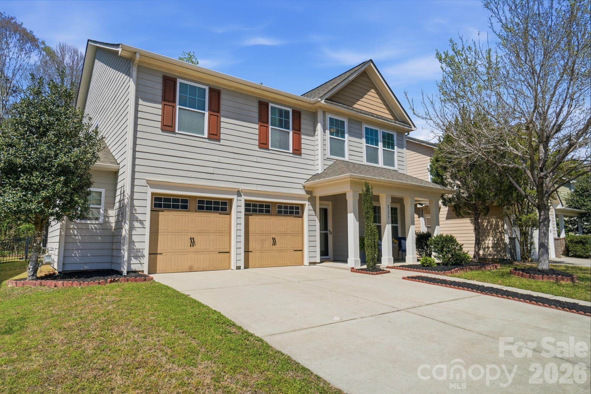 2153 Bluebell Way Tega Cay, SC 29708 - Photo 3 of 48 a front view of a house with a yard