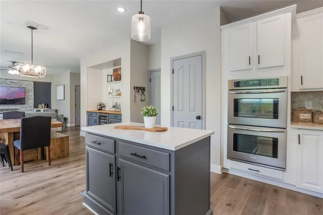 a kitchen with a sink stove and microwave