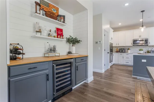 a kitchen with stainless steel appliances granite countertop a sink and cabinets