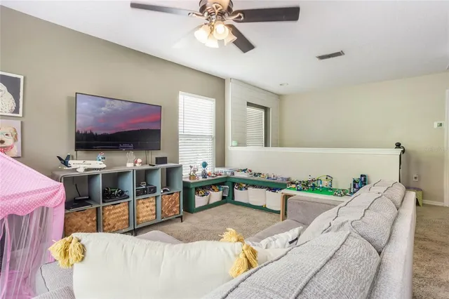 a living room with furniture and flat screen tv