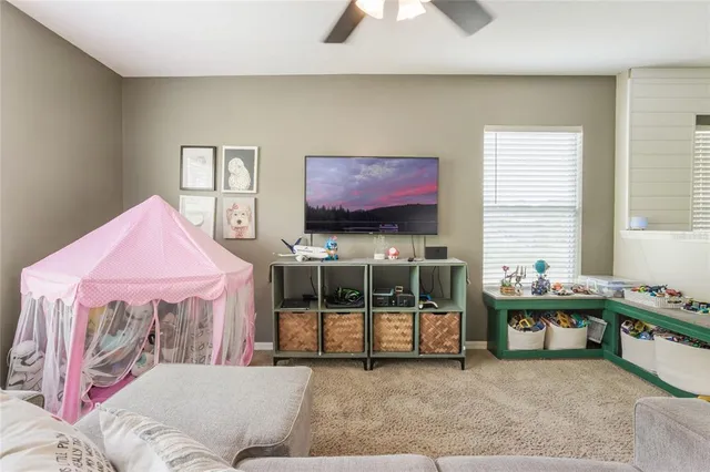 a bedroom with furniture and a large window