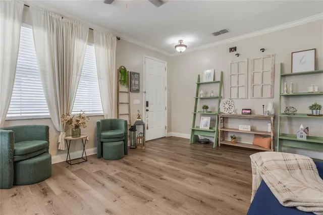 a bedroom with furniture and a wooden floor