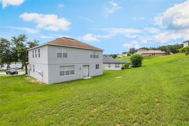 a view of house with yard and green space