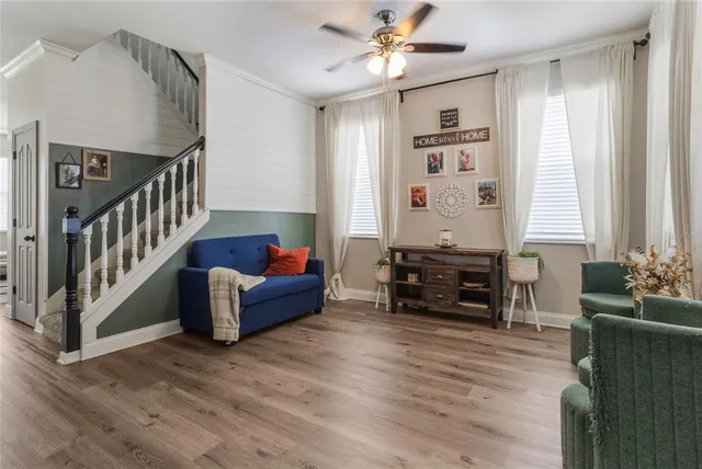 a living room with furniture and wooden floor
