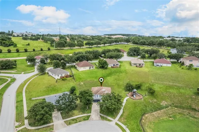 an aerial view of a house with outdoor space