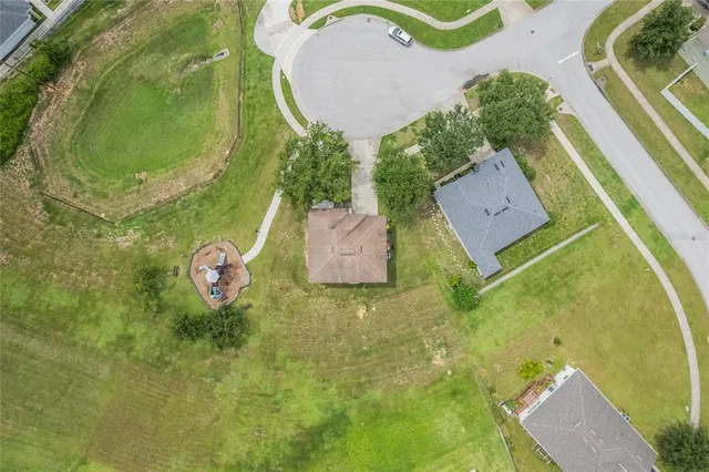 an aerial view of a house with swimming pool and outdoor space