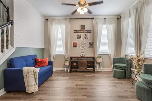 a living room with furniture window and wooden floor