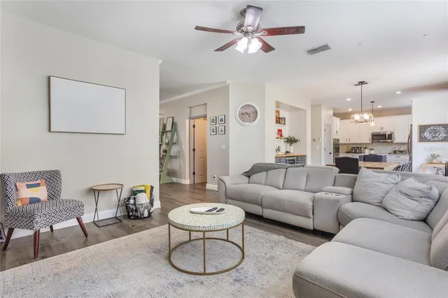 a living room with furniture a rug and a chandelier
