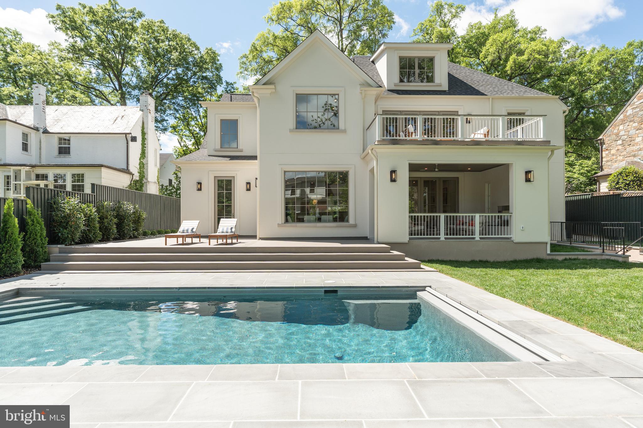 4821 Rodman Street Northwest Washington, DC 20016 - Photo 2 of 52 a front view of a house with a garden and yard